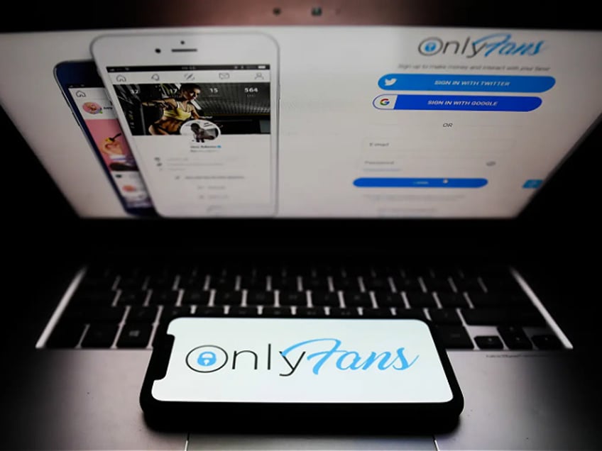 OnlyFans logo displayed on a phone screen and a website displayed on a laptop screen are seen in this illustration photo taken in Krakow, Poland on April 27, 2021. (Photo Illustration by Jakub Porzycki/NurPhoto via Getty Images)
