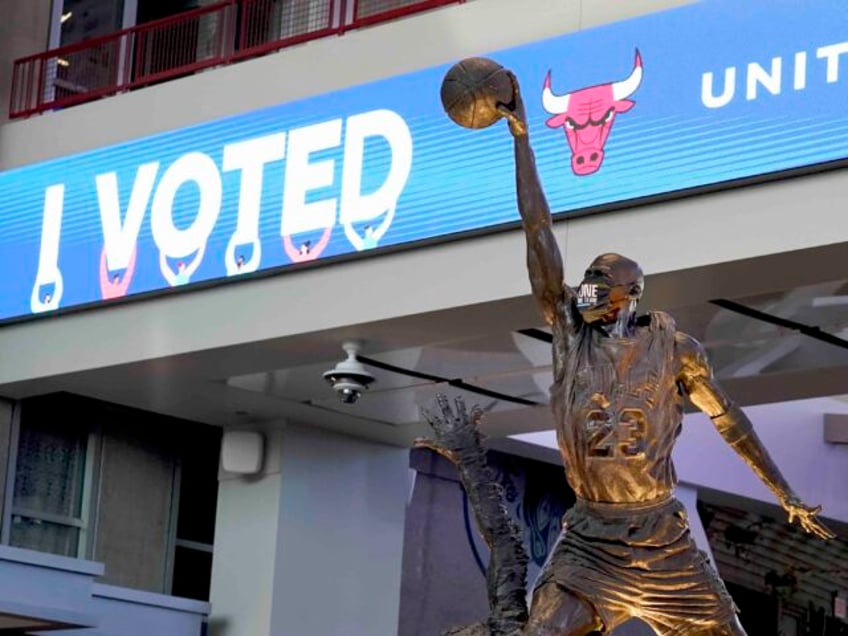 The Michael Jordan statue stands in front of an I Voted banner on Election Day, Tuesday, N