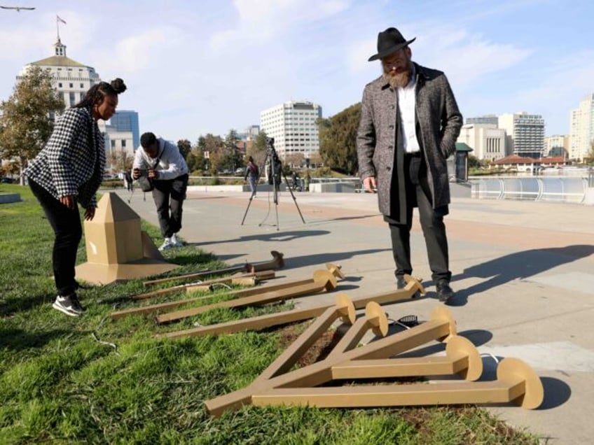 OAKLAND, CALIFORNIA - DECEMBER 13: Rabbi Dovid Labkowski, of the Chabad Jewish Center of Oakland, looks at a damaged menorah at the Lake Merritt Amphitheater in Oakland, Calif., on Wednesday, Dec. 13, 2023. Vandals on Tuesday night destroyed the large menorah which was set out for the public. (Jane Tyska/Digital …