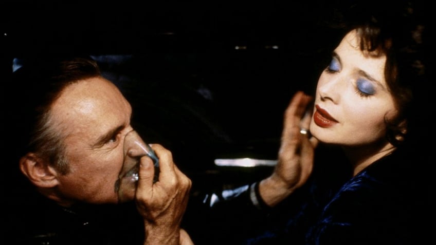 Dennis Hopper wearing an oxygen mask in a scene with Isabella Rossellini in Blue Velvet