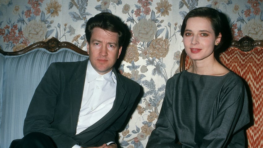 David Lynch and Isabella Rossellini sitting in chairs together in the late 1980s