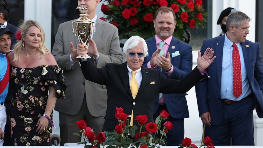 Bob Baffert holds trophy