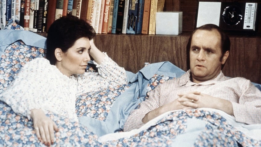 Suzanne Pleshette and Bob Newhart in bed in a scene from The Bob Newhart Show