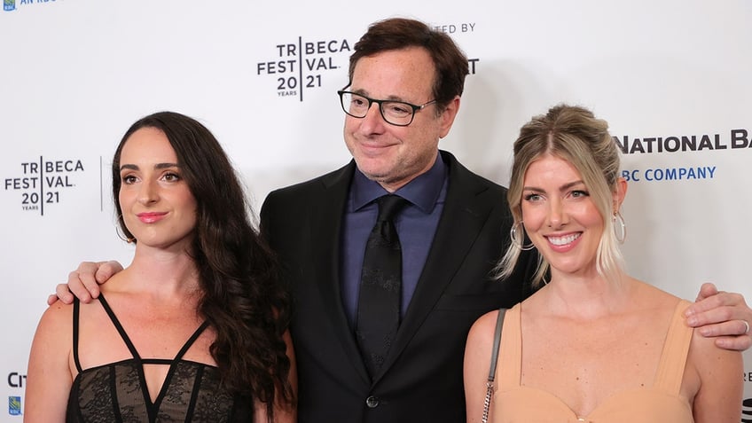 Lara Saget, Bob Saget and Kelly Rizzo on the red carpet in good spirits lookig to their left