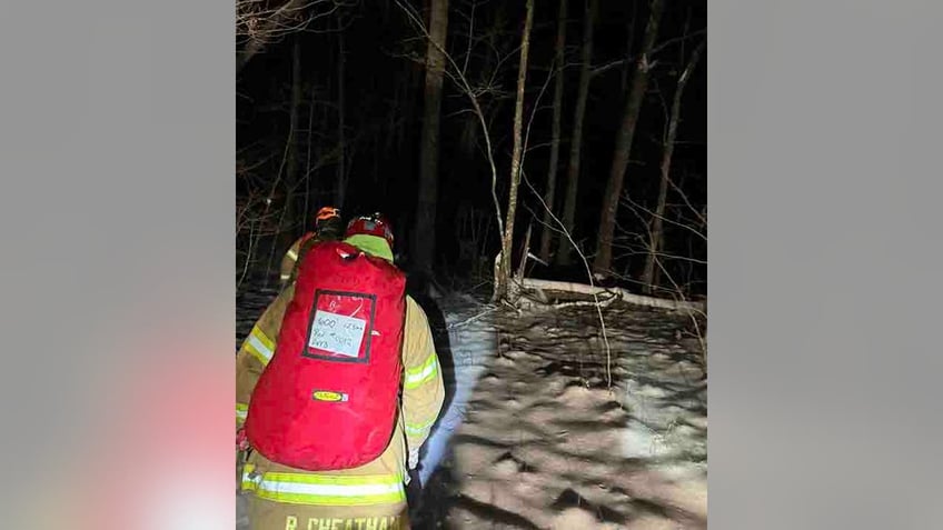 rescuers hiking in woods