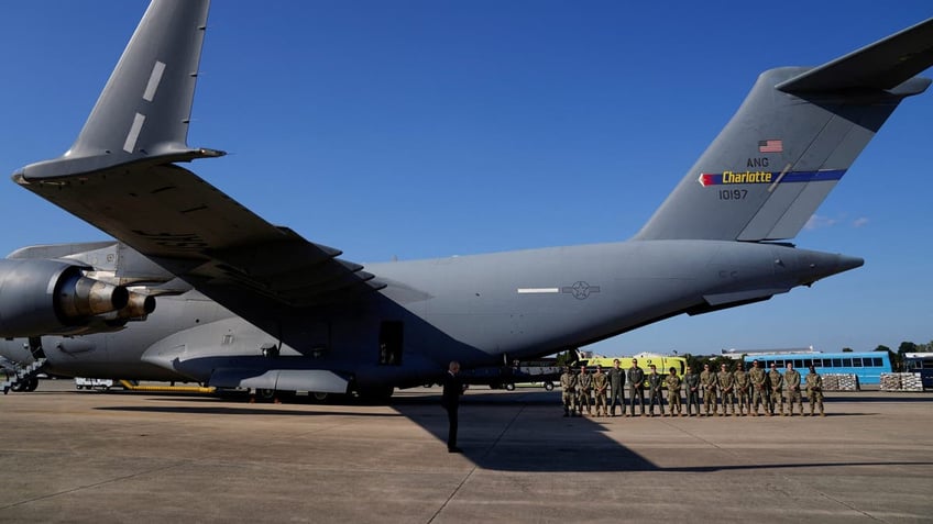 Crew members of C-17 transport aircraft of 145th Airlift Wing of the North Carolina Air National Guard wait to meet Vice President Kamala Harris, in the wake of Hurricane Helene in Charlotte, North Carolina, on Oct. 5, 2024.