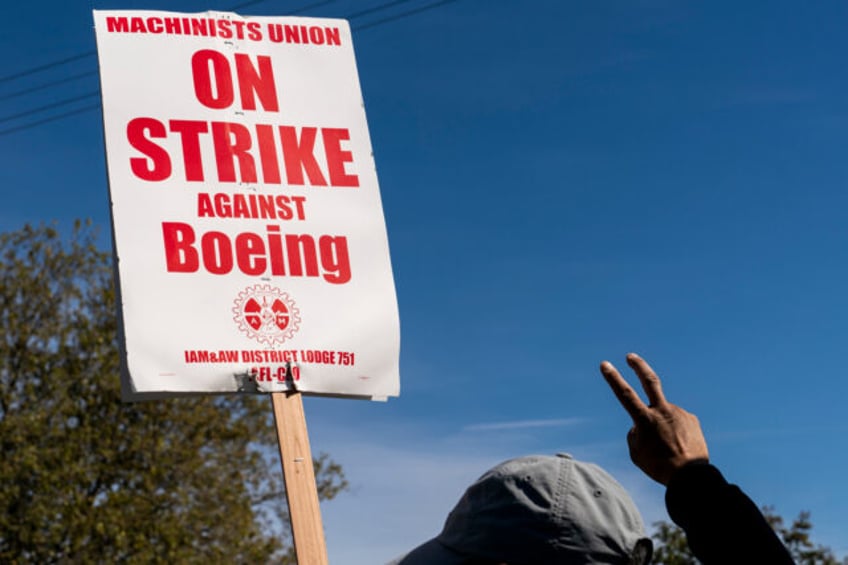 A worker pickets outside the Boeing Co. manufacturing facility during a strike in Renton,