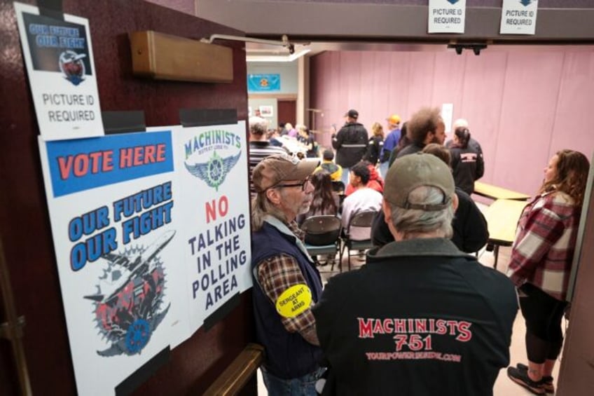 People look on as the Boeing Machinist union tallies votes on the latest Boeing contract o