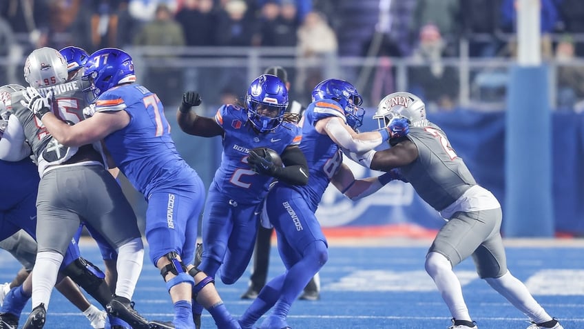 Running back Ashton Jeanty of the Boise State Broncos busts through a whole in the line during the first half of the Mountain West Championship against the UNLV Rebels at Albertsons Stadium on December 06, 2024 in Boise, Idaho.