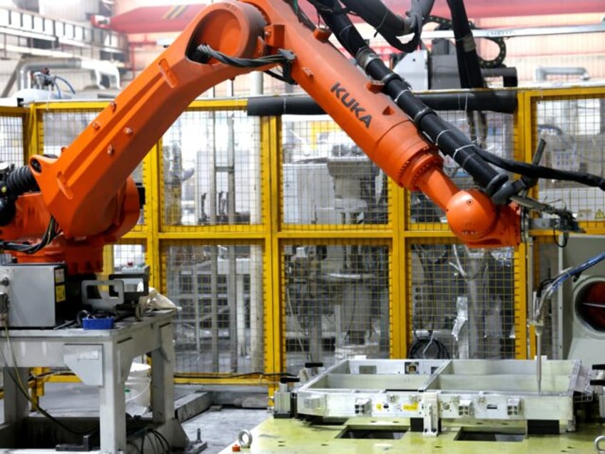 A robot in the production workshop of a new energy enterprise produces new energy vehicle