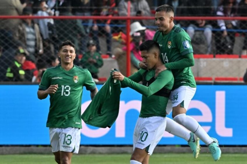 Bolivia's forward Ramiro Vaca (center) celebrates scoring his team's opening goal in Thurs