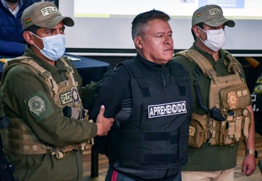 Bolivia's now-dismissed army chief General Juan Jose Zuniga (C) is escorted by policemen f