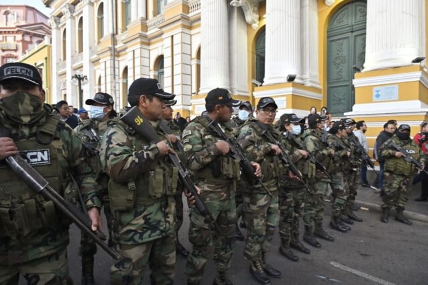 Police officers stand guard at Plaza Murillo in La Paz after soldiers and tanks took up po