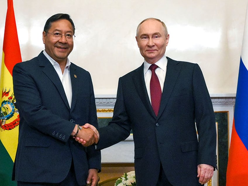 Russia's President Vladimir Putin, right, and Bolivia's President Luis Arce pose for a pho