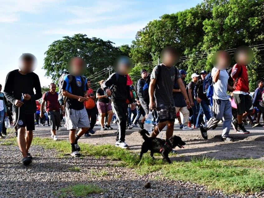 Migrants walk on an US-bound caravan on the outskirts of Tapachula, State of Chiapas, Mexi