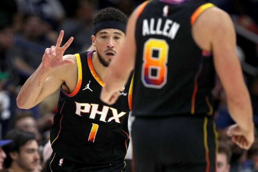 Devin Booker reacts to a three-pointer on his way to a 52-point display in Phoenix's win o