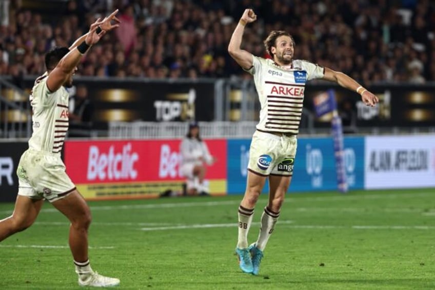 Jump for joy: Bordeaux scrum-half Yann Lesgourgues (R) celebrates victory