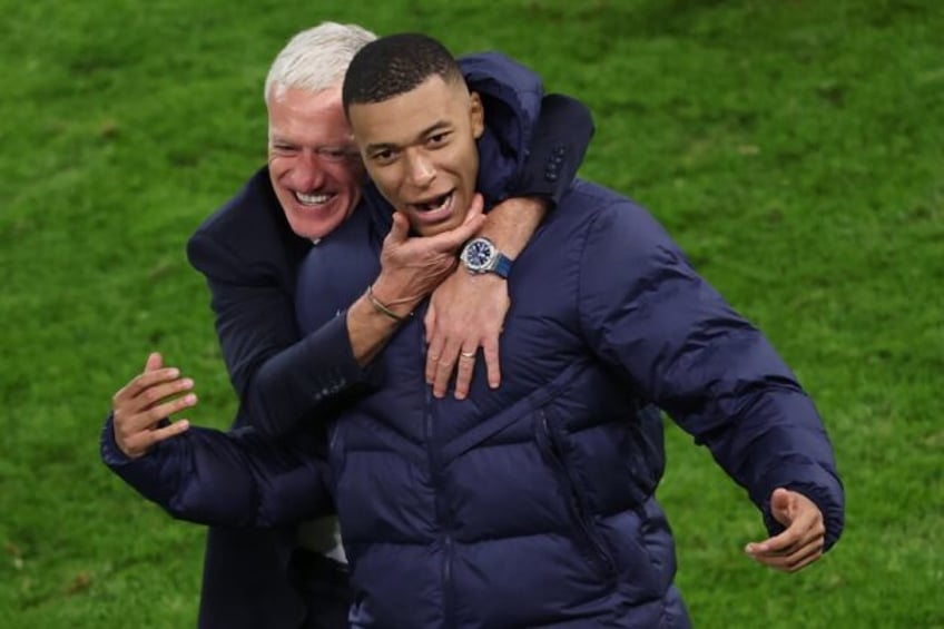 France coach Didier Deschamps celebrates with Kylian Mbappe after the penalty shoot-out wi