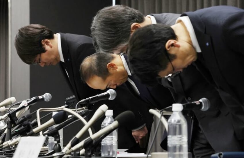 Kobayashi Pharmaceutical president Akihiro Kobayashi (2nd L) and others bow at a press con