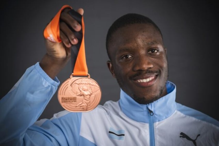 Letsile Tebogo from Botswana shows his 200 metres bronze medal after the 2023 world champi