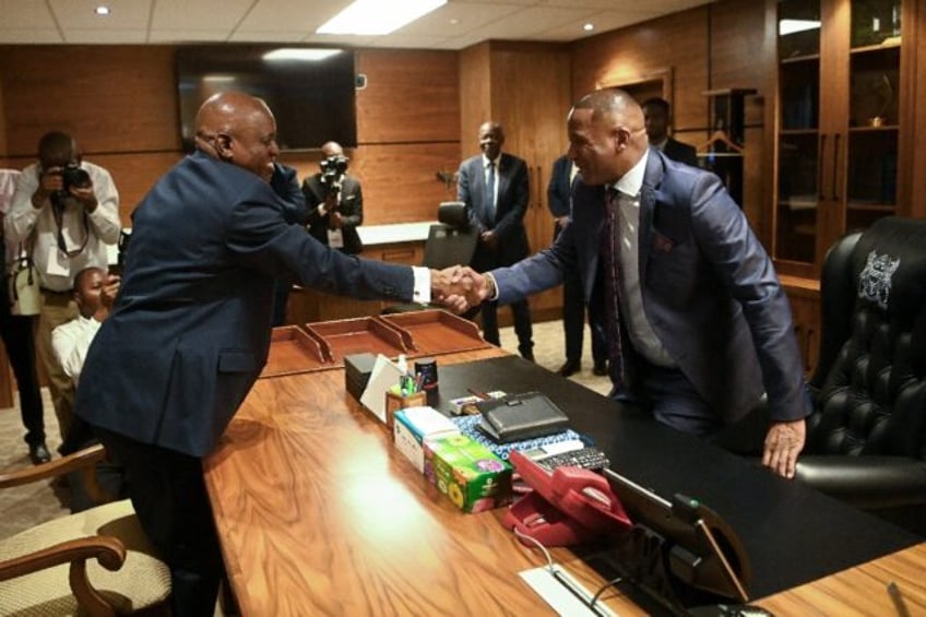 Botswana’s newly elected President Duma Boko (R) takes over from outgoing president Mokg