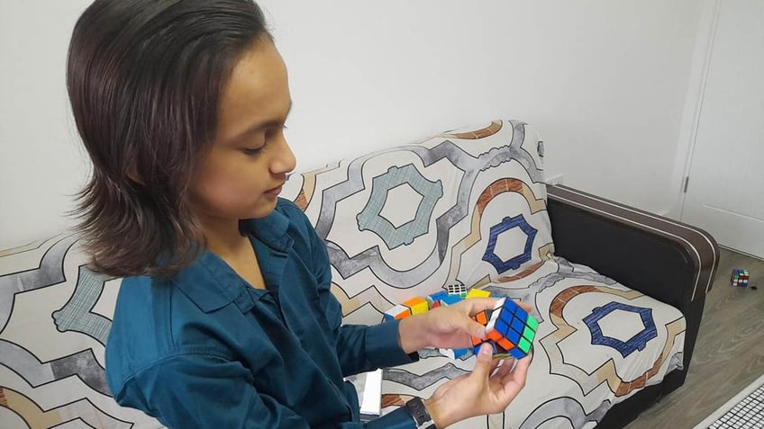 Henil Soni holding a Rubik's Cube