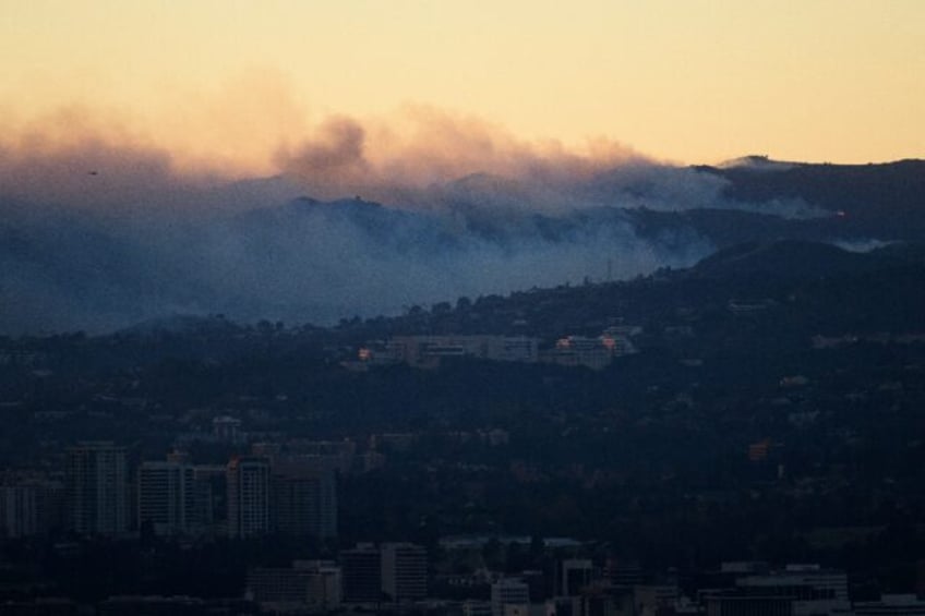 Flames and smoke behind the Getty Center museum on January 8, 2025