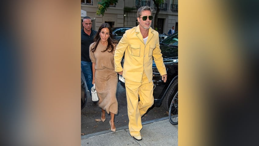 Brad Pitt and Ines de Ramon out in New York City in yellow and brown.