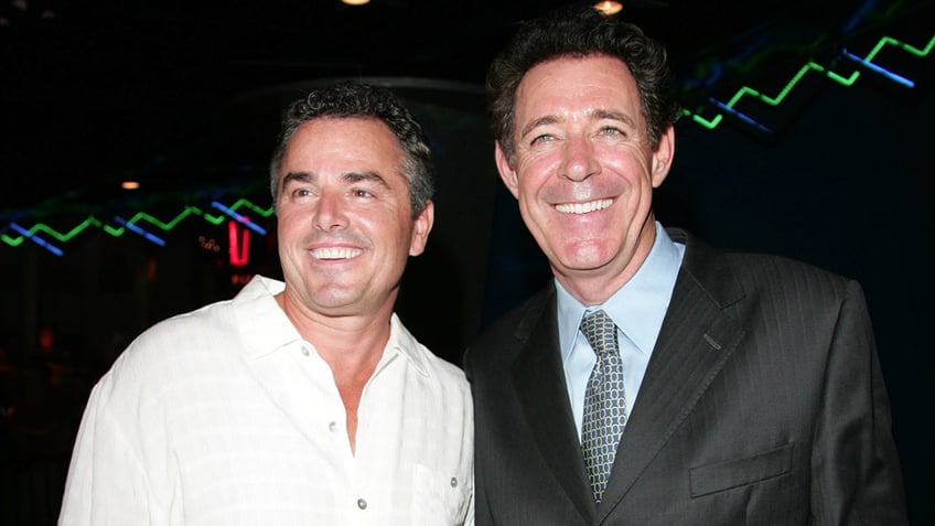 Christopher Knight and Barry Williams posing together