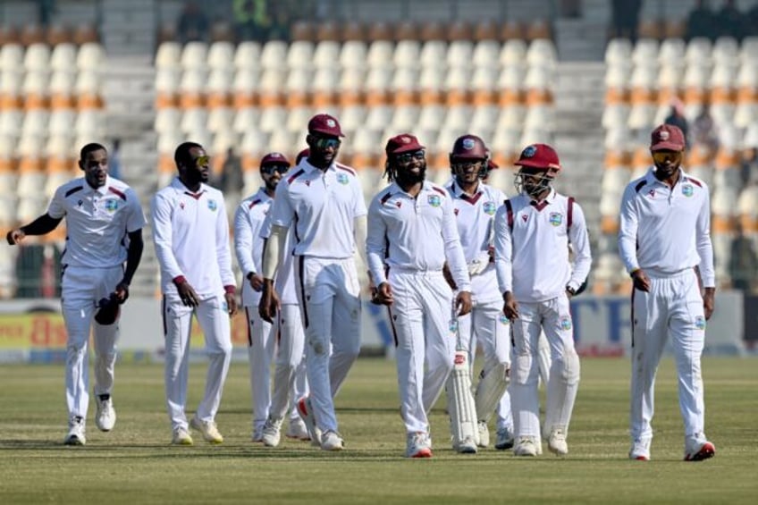 West Indies spin bowler Jomel Warrican and his team mates leave the ground after defeating