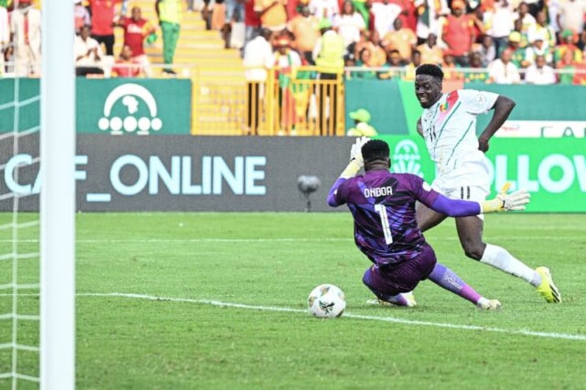 Mohamed Bayo (R) scores for Guinea against Cameroon in Yamoussoukro.