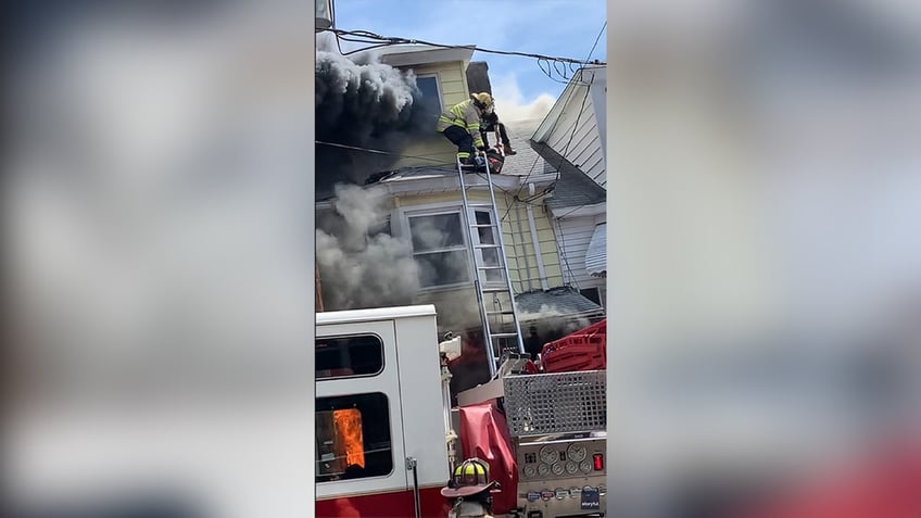 Oscar Rivera rescues a resident from a burning home
