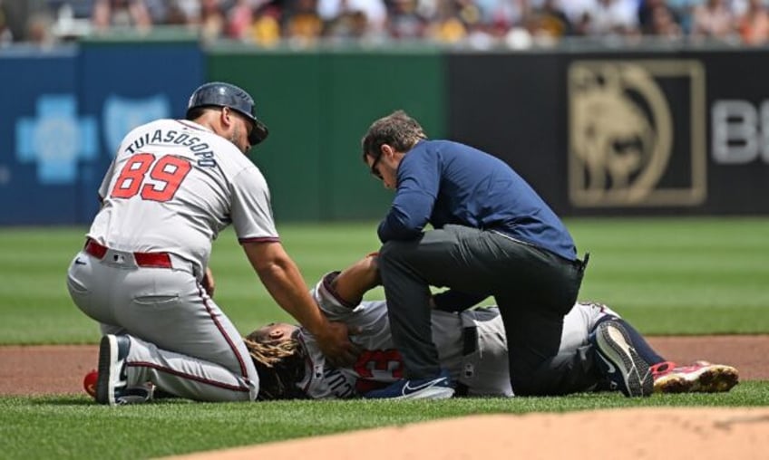 Ronald Acuna of the Atlanta Braves is attended to after suffering a season-ending torn kne