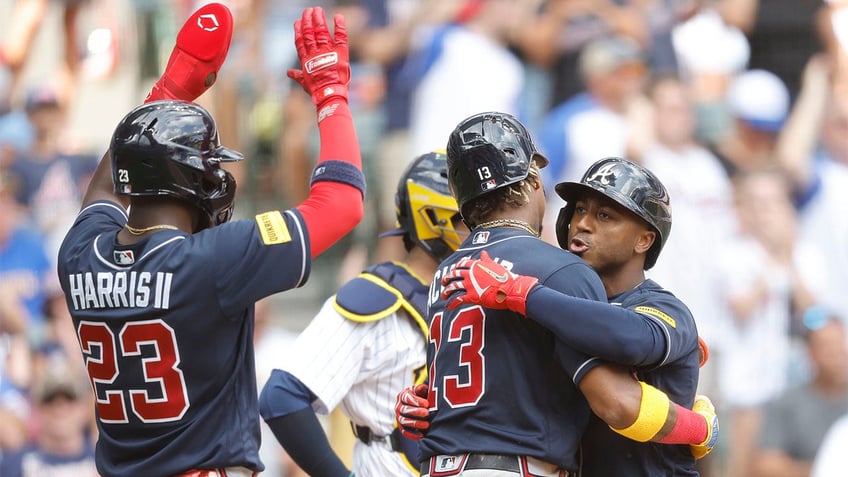 braves rally behind ozzie albies clutch three run home run in win over brewers