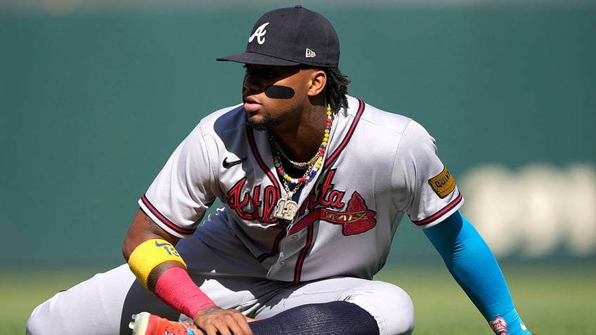 braves ronald acuna jr knocked over in wild scene at coors field as security wrestles fans wanting hug