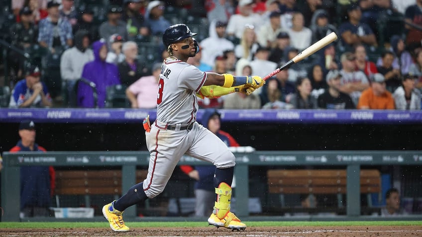 braves ronald acuna jr knocked over in wild scene at coors field as security wrestles fans wanting hug