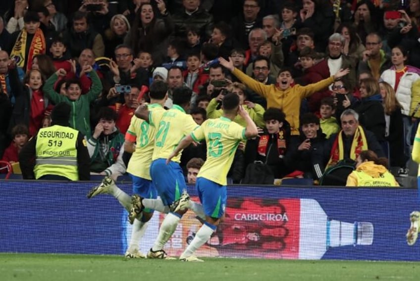 Brazil midfielder Lucas Paqueta (L) celebrates scoring his team's third goal in the draw a
