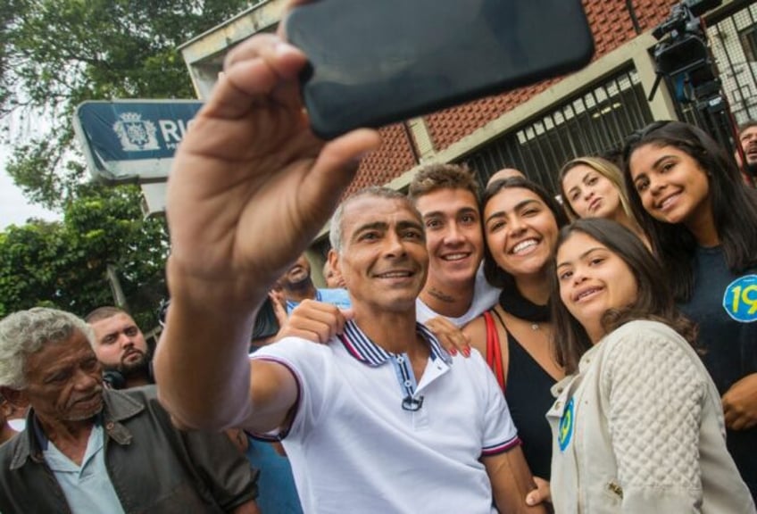 Brazilian senator and football legend Romario takes a selfie with his family after voting