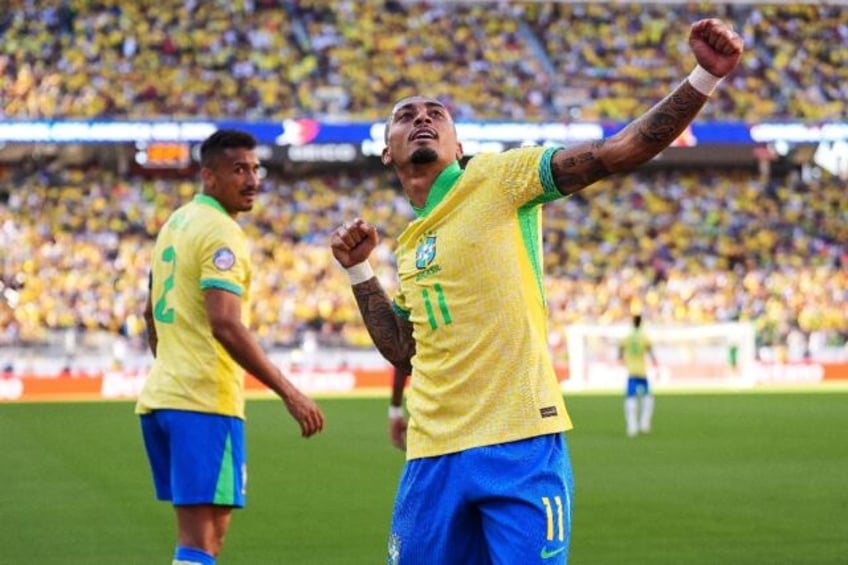 Brazil forward Raphinha celebrates his goal in the 1-1 draw with Colombia