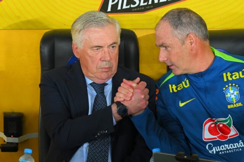 Brazil's Italian head coach Carlo Ancelotti shakes hands with his English assistant Paul C