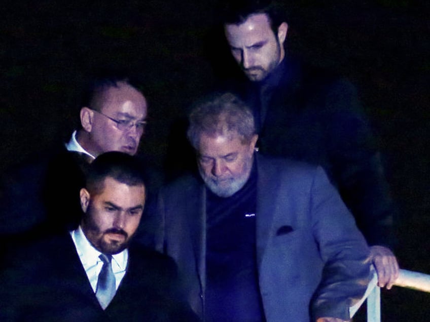 Brazilian ex-president (2003-2011) Luiz Inacio Lula da Silva arrives at the Federal Police headquarters where he is due to serve his 12-year prison sentence, in Curitiba, Parana State, Brazil, on April 7, 2018. - Brazil's election frontrunner and controversial leftist icon said Saturday that he will comply with an arrest warrant to start a 12-year sentence for corruption. "I will comply with their warrant," he told a crowd of supporters. (Photo by Heuler Andrey / AFP) (Photo credit should read HEULER ANDREY/AFP via Getty Images)