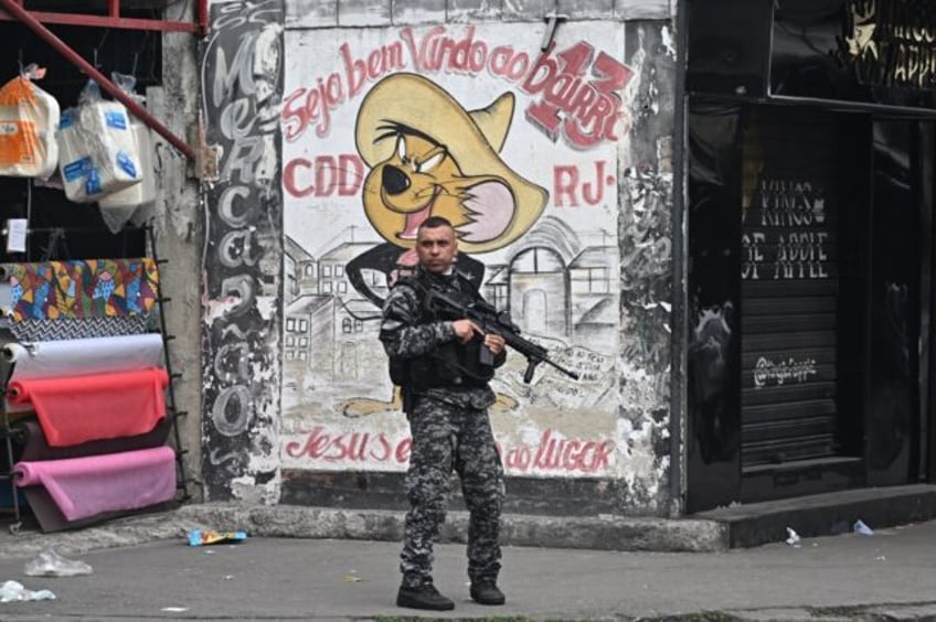 A Military Police officer patrols a street in the Cidade de Deus (City of God) favela inRi