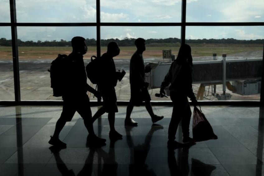 Brazilians deported from US walk at Eduardo Gomes International Airport in Manaus, Amazon