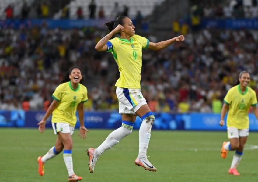 Adriana celebrates after scoring Brazil's third goal in their stunning win against Spain