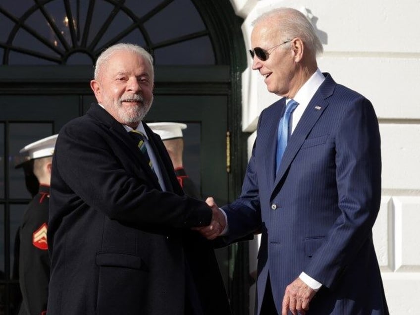 President Joe Biden (R) shakes hands with Brazilian President Luiz Inacio Lula da Silva (L