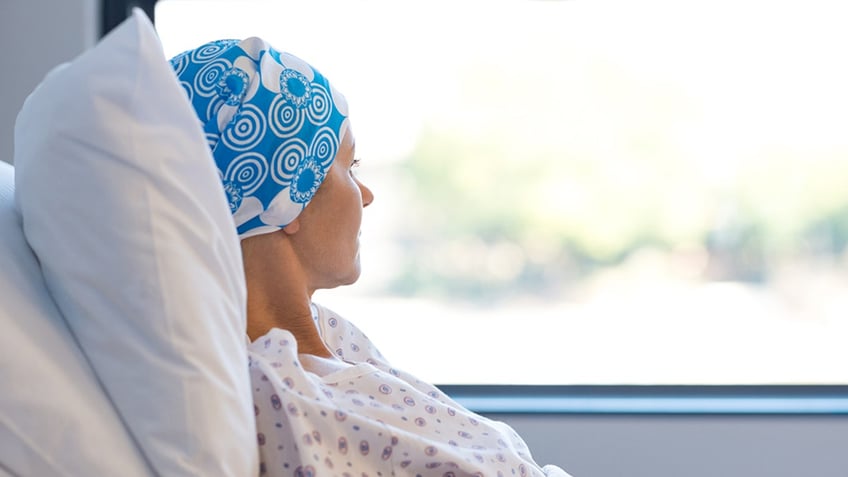 Cancer patient looks out window