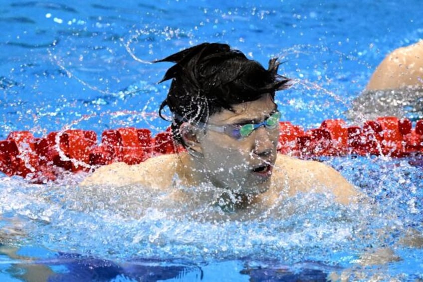 breaststroke king qin fires asian games warning