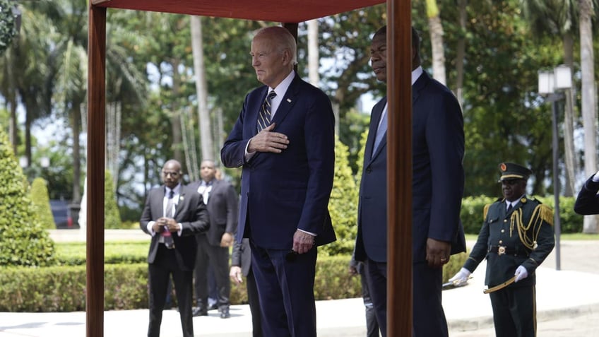 President Joe Biden stands for national anthems with Angola's President Joao Lourenco, at the presidential palace in the capital Luanda, Angola on Tuesday, Dec. 3, 2024. (AP Photo/Ben Curtis)