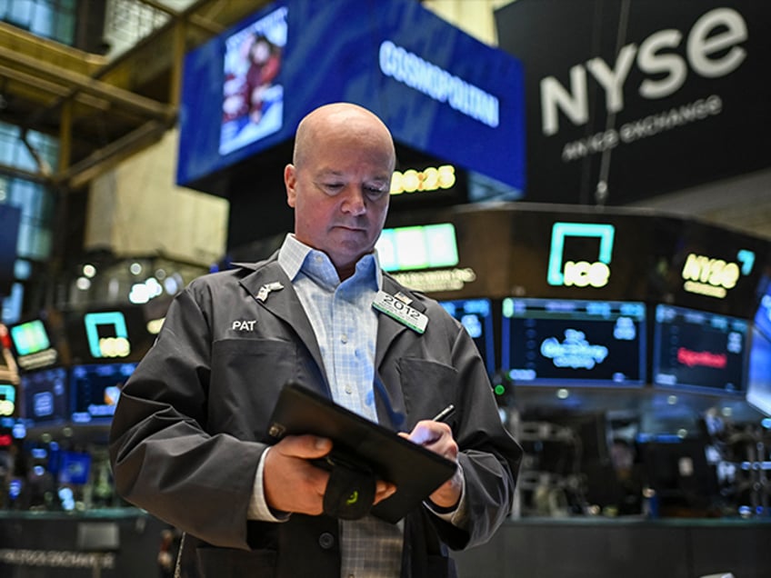 Traders work on the floor of the New York Stock Exchange (NYSE) at the opening bell in New