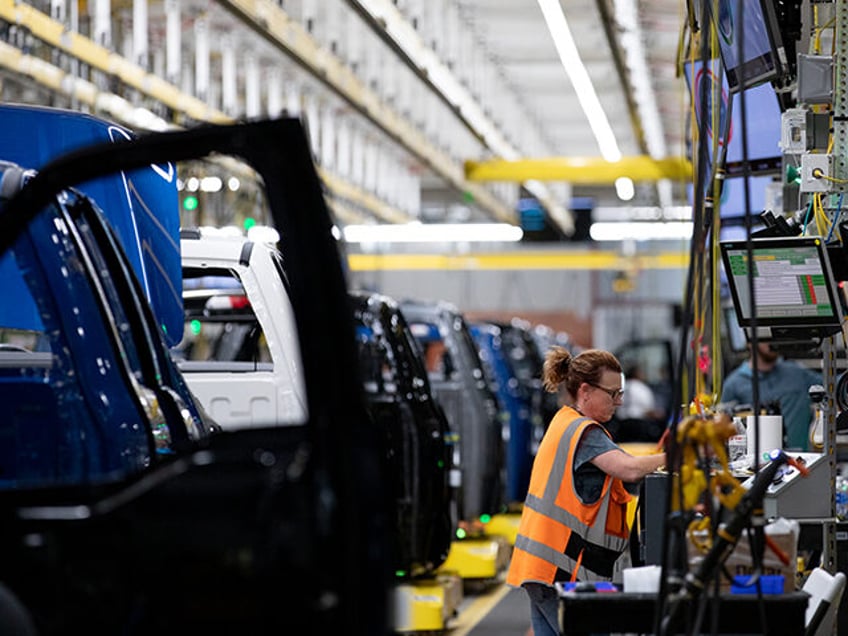 An auto worker works the production line at the Ford Motor Co. Rouge Electric Vehicle Cent